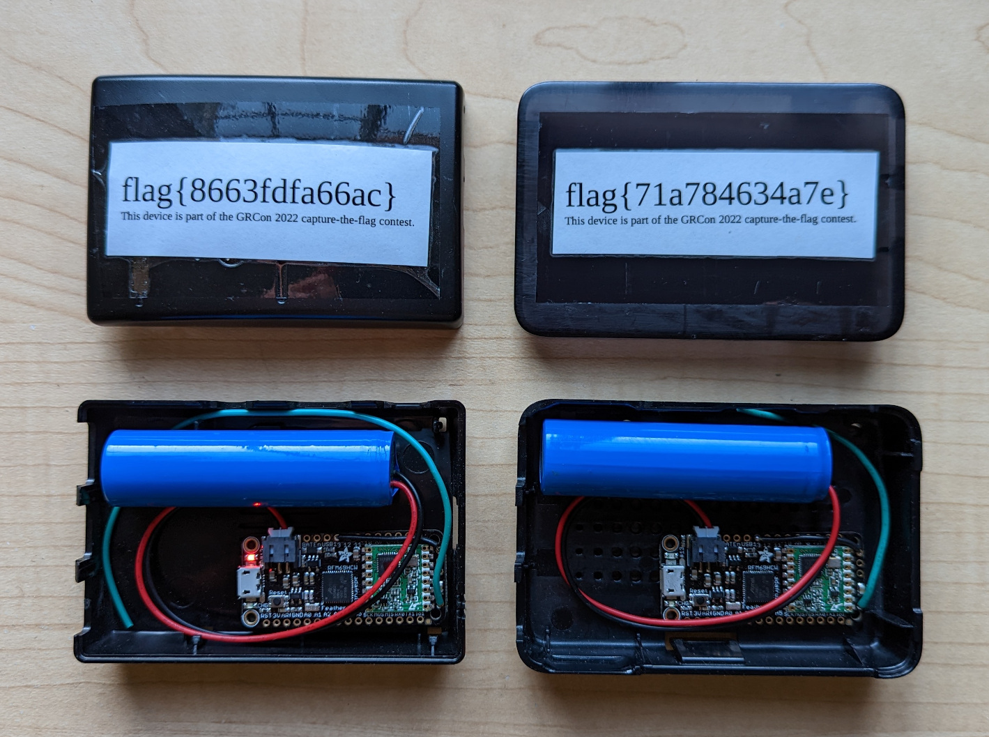 Two hidden transmitters sitting on a table with covers removed